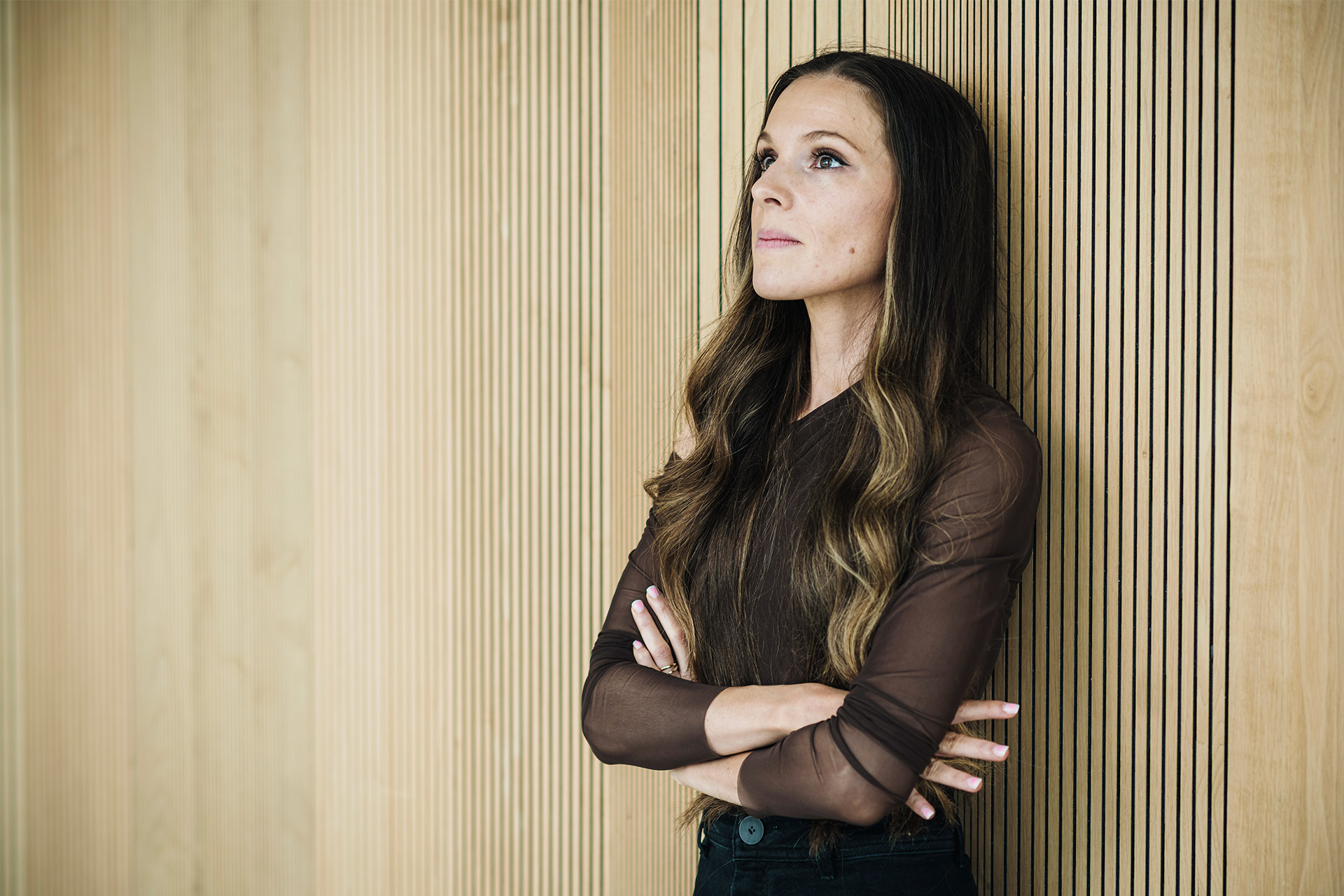 Isabella Hindkjær står med ryggen til væggen og ser reflekterende ud i luften