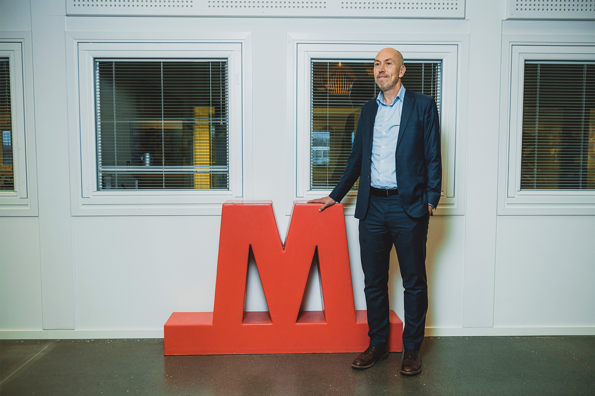 Jakob Keinicke Sørensen står ved siden af Metro-skilt på kontoret