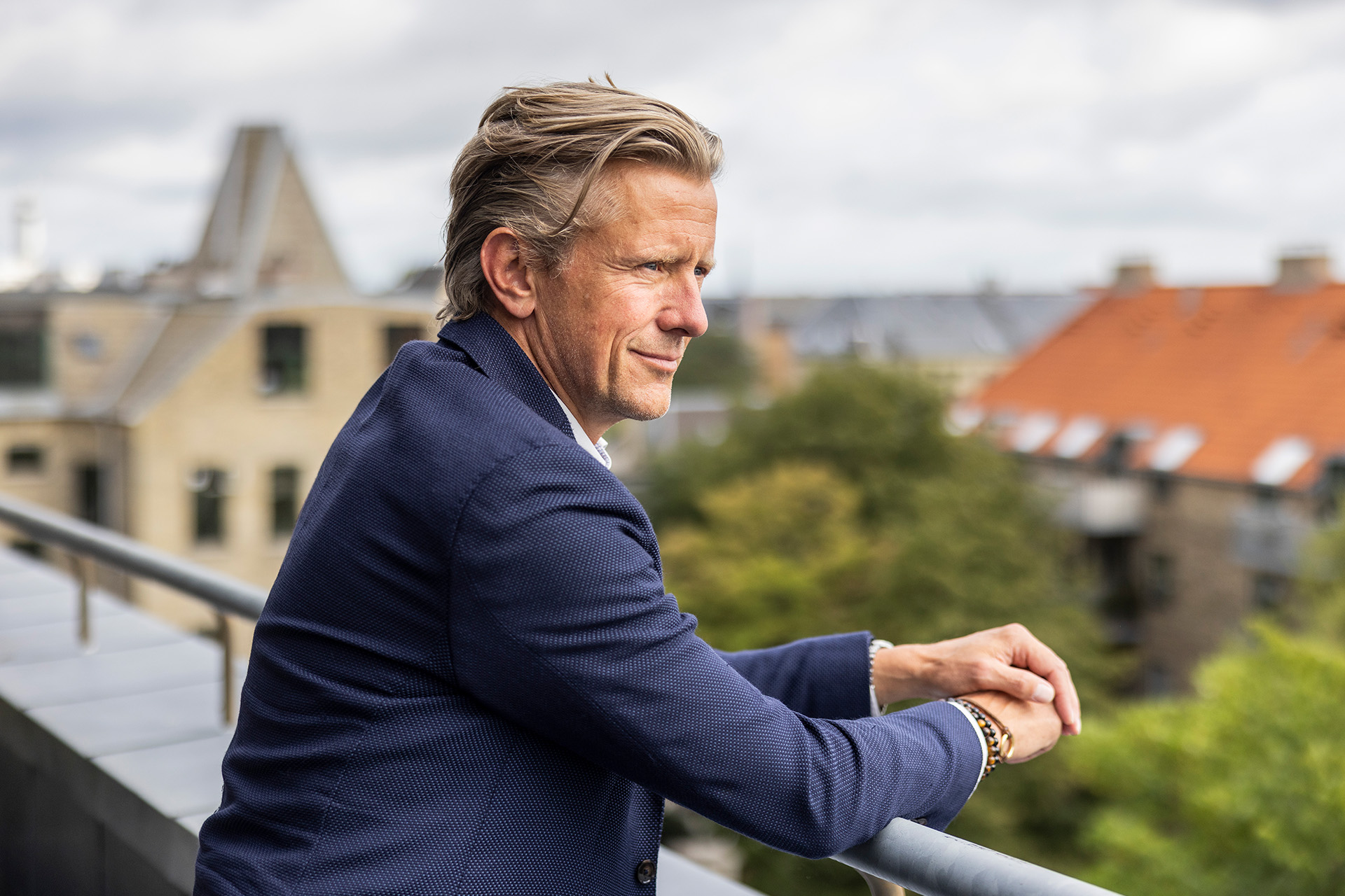 Mads Friis står på balkon og ser ud over byen