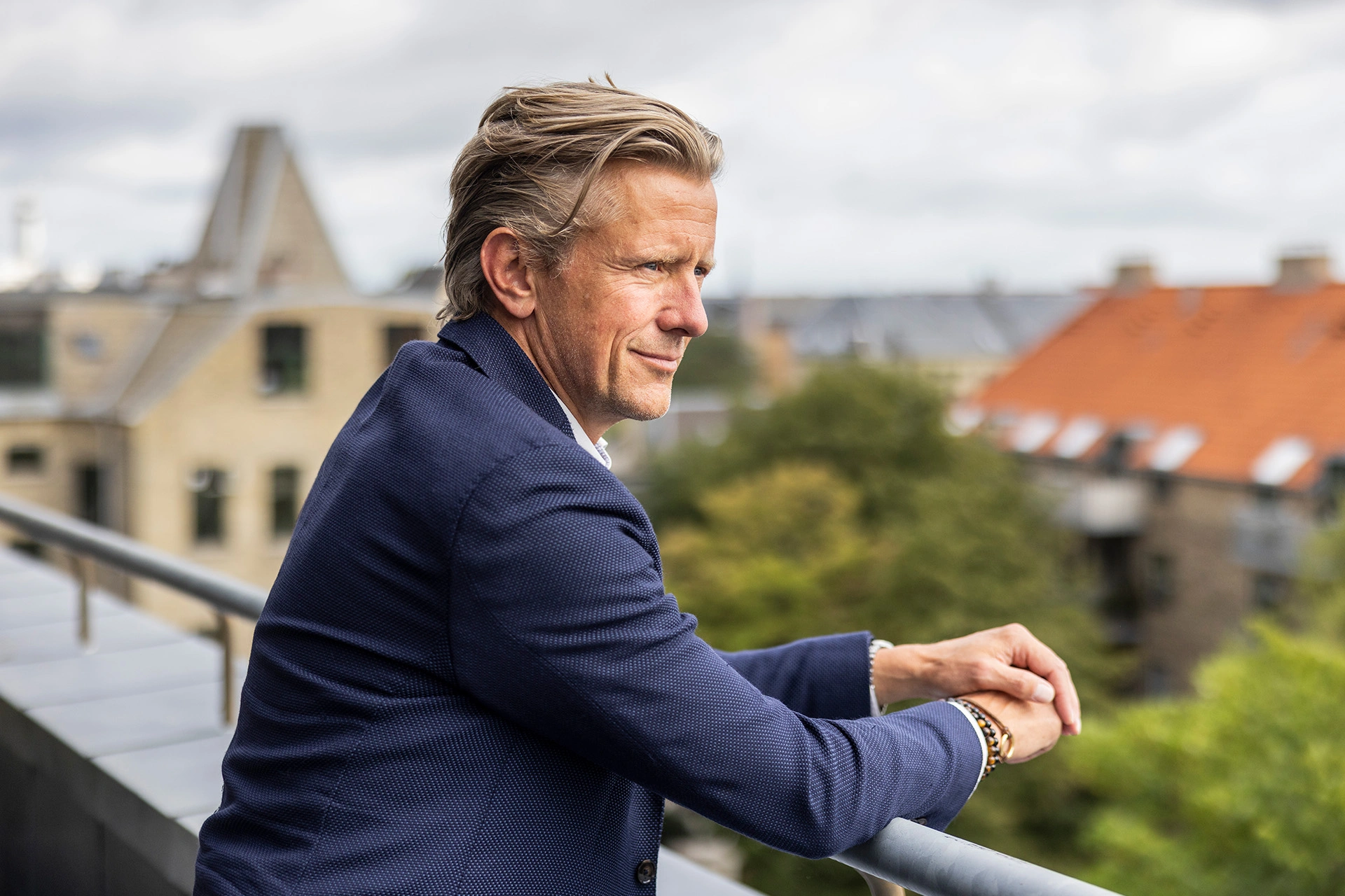 Mads Friis står på balkon og ser ud over byen
