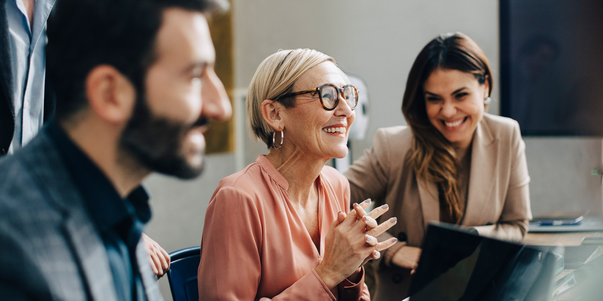 En ældre kollega sidder med sine kolleger