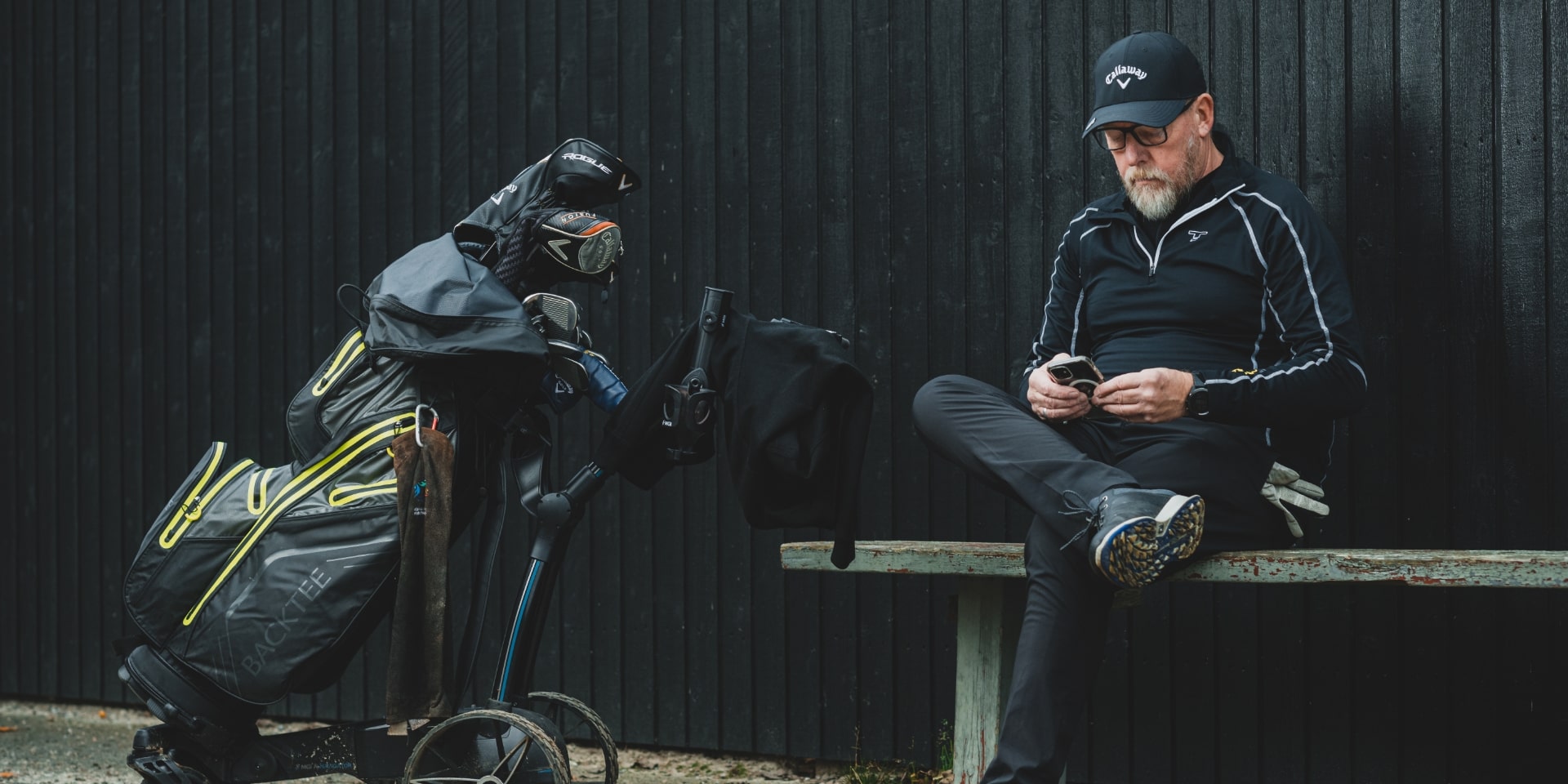 Maks Jørgensen sidder ved sin golftaske på en bænk