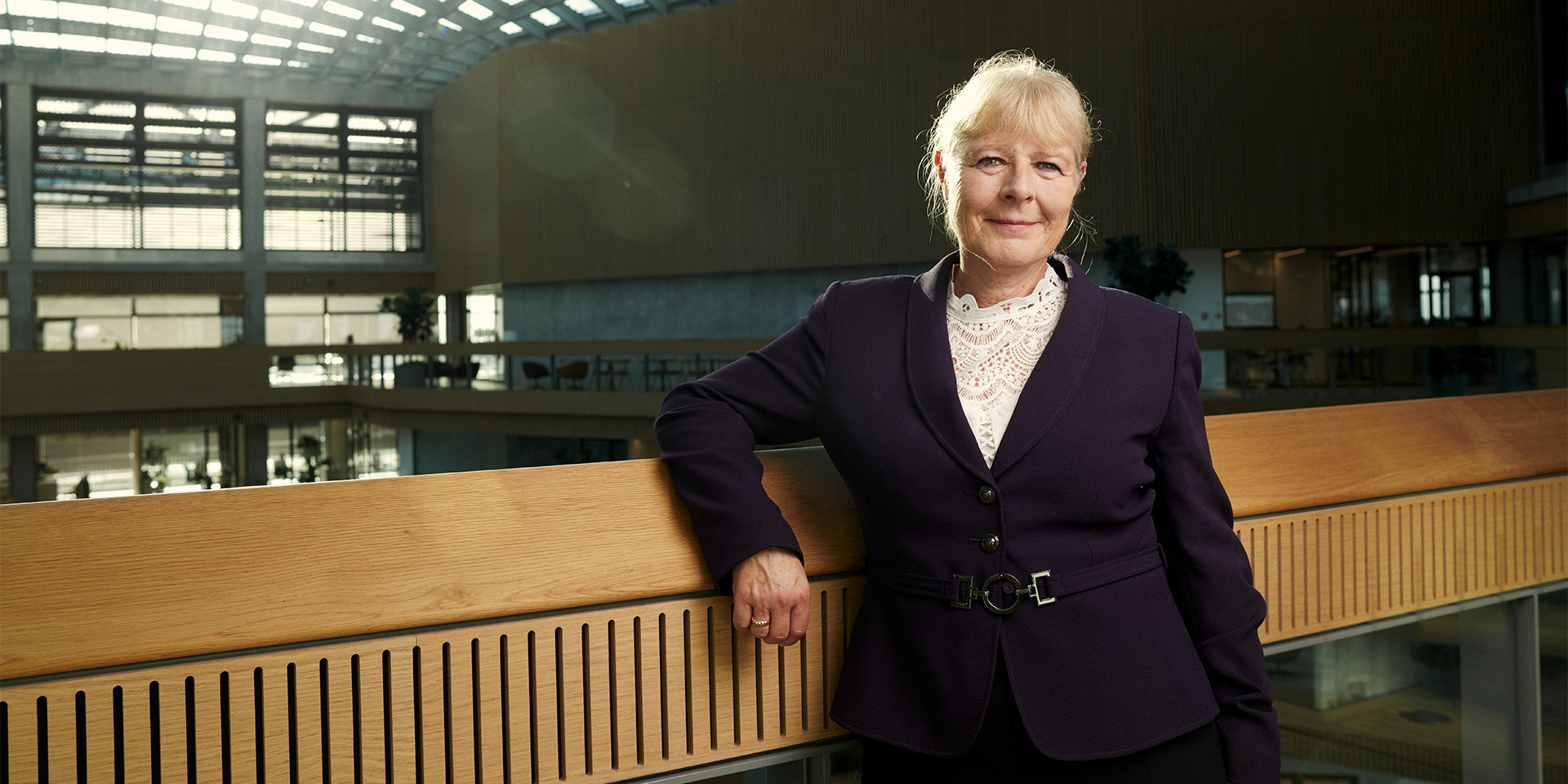 Marianne Kock læner sig på af et træværk på kontoret